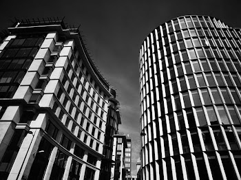 Grayscale Photograph of High-rise Concrete Buildings