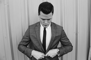 grayscale photograph of man wearing suit