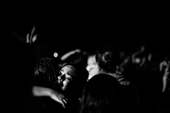 grayscale photograph of two person hugging