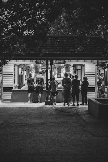 Grayscale Photography Group of Person Standing Indoors