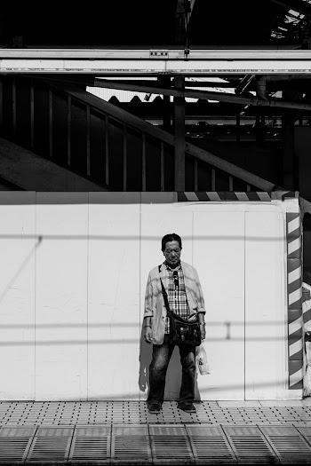 Grayscale Photography Man Standing Near the Wall