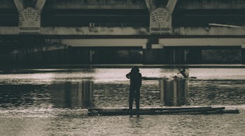 Grayscale Photography of a Woman Beside Body of Water