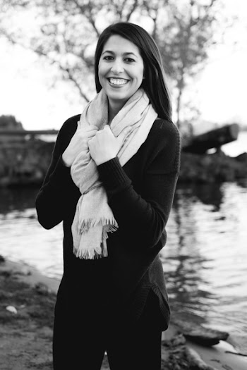 Grayscale Photography of a Woman Wearing Sweatshirt and Black Pants While Holding Scarf