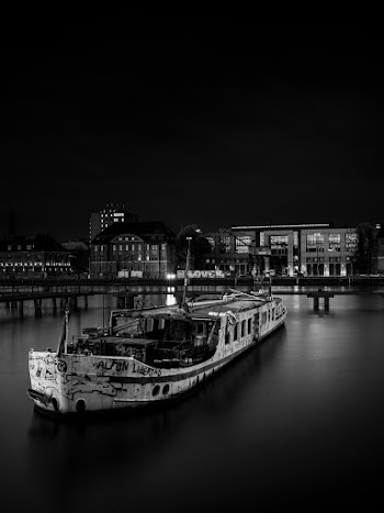 Grayscale Photography of Boat on Body of Water
