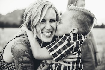 Grayscale Photography of Boy Kissing Woman Face
