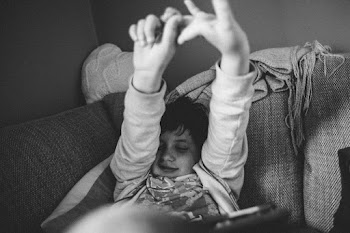 Grayscale Photography of Boy Lying on Sofa