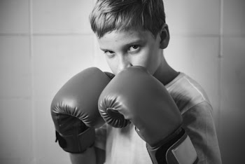 Grayscale Photography of Boy Wearing Boxing Gloves