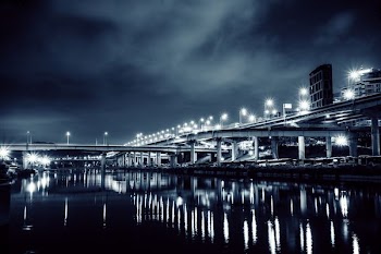 grayscale photography of bridge at night