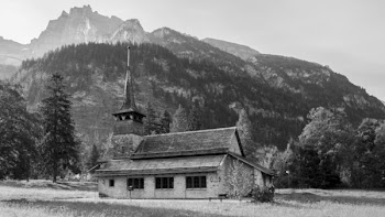 Grayscale Photography of Building Near Mountain
