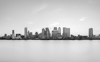 grayscale photography of buildings near body of water