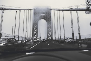 Grayscale Photography of Cars on Bridge