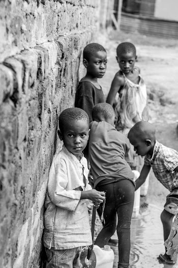 Grayscale Photography of Children Near the Wall