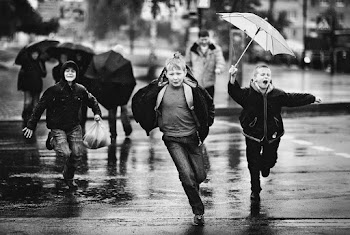 Grayscale Photography of Children Running on Road in Rainy Day