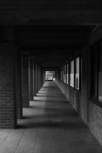 Grayscale Photography of Concrete Hallway