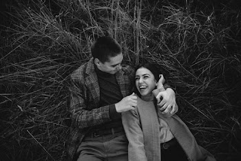 Grayscale Photography of Couple on Plant Field
