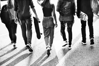 Grayscale Photography of Five People Walking on Road
