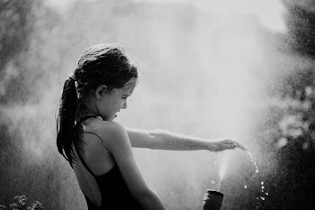 grayscale photography of girl playing water