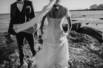 grayscale photography of groom and bridge on seashore during daytime