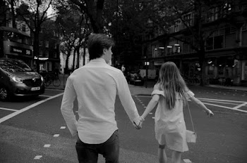 Grayscale Photography of Man and Woman Holding Hands on Road