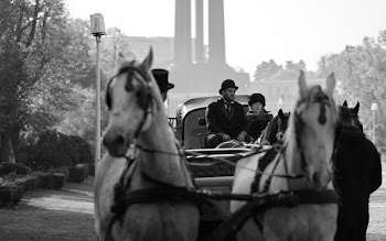 Grayscale Photography of Man and Woman Riding Carriage