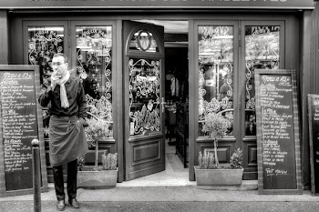 Grayscale Photography of Man Beside Store