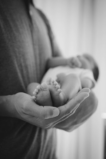 Grayscale Photography of Man Carrying Baby
