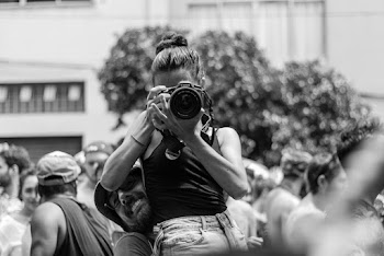 Grayscale Photography Of Man Carrying Woman While Taking Picture