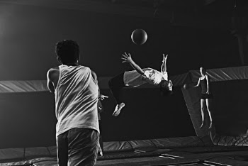 Grayscale Photography Of Man Doing Backflip