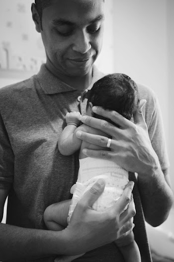 Grayscale Photography of Man Holding Baby