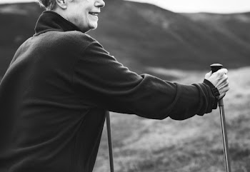 Grayscale Photography of Man Holding Cane Walker