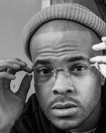 Grayscale Photography of Man Holding His Eyeglasses