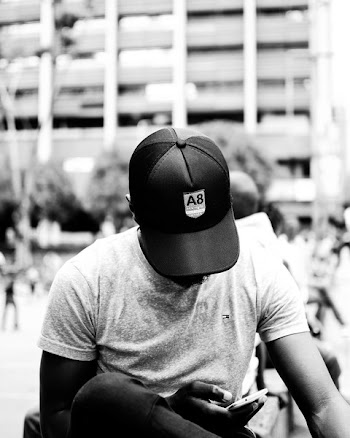 Grayscale Photography of Man Holding Smartphone