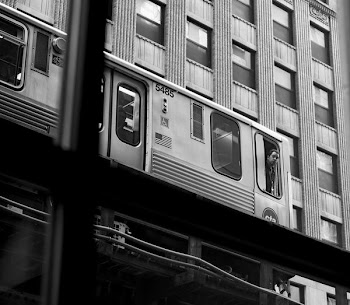 grayscale photography of man leaning outside train window