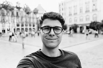 Grayscale Photography of Man Near Bulding