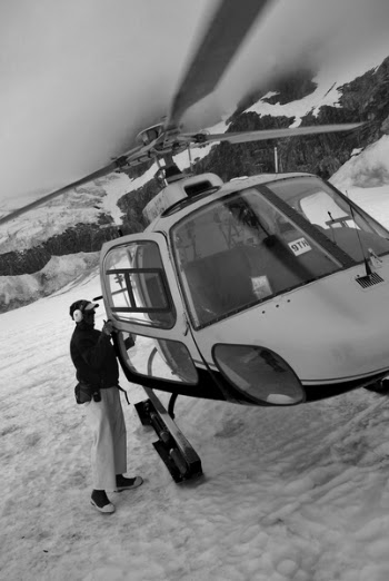 Grayscale Photography of Man Opening Helicopter Door