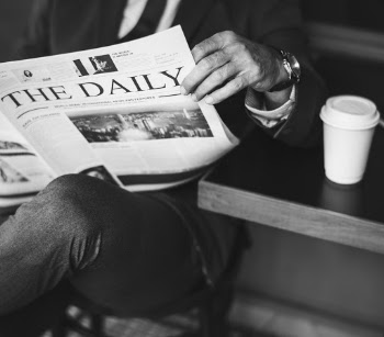 Grayscale Photography of Man Reading Newspaper