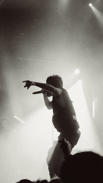 Grayscale Photography of Man Singing on Stage