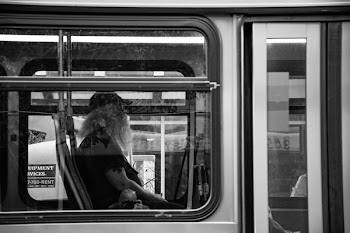 Grayscale Photography of Man Sitting Inside Bus