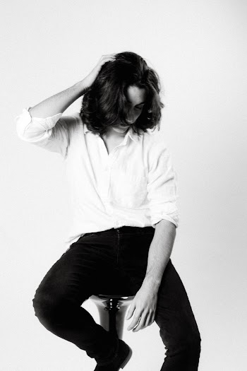 Grayscale Photography of Man Sitting on Bar Stool