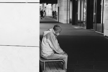 Grayscale Photography of Man Sitting on Chair