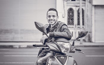 Grayscale Photography of Man Sitting on Motorcycle