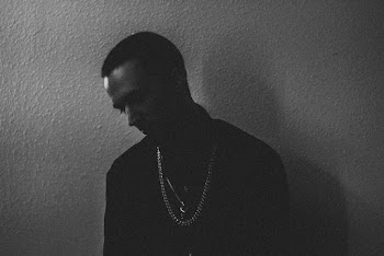 Grayscale Photography of Man Standing Against the Wall and Looking Down