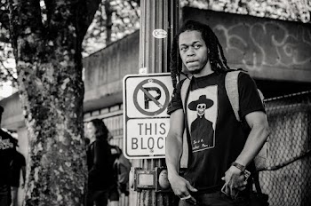Grayscale Photography of Man Standing Near Signage