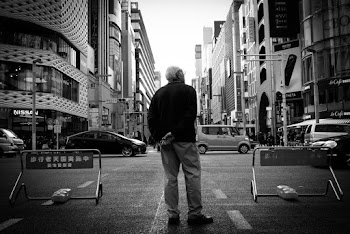 Grayscale Photography of Man Standing on Road