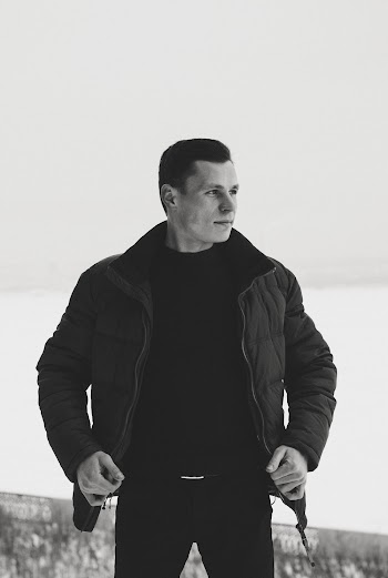 Grayscale Photography of Man Wearing Bubble Jacket