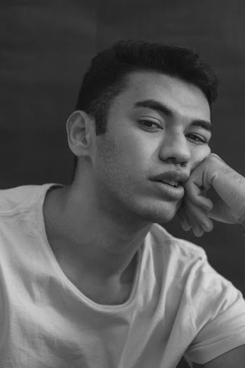 Grayscale Photography of Man Wearing Crew-neck Shirt Resting Head on Left Hand