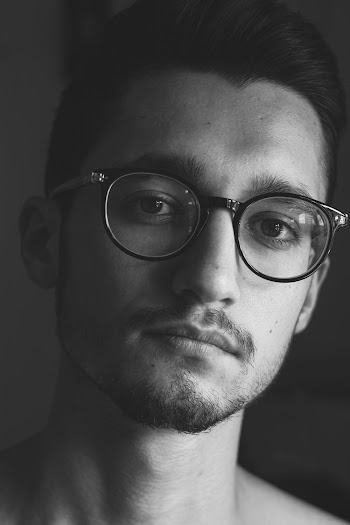 Grayscale Photography of Man Wearing Eyeglasses