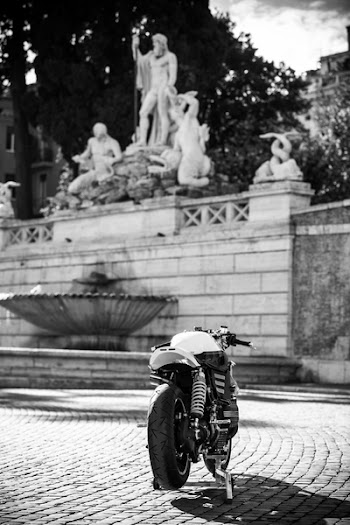 Grayscale Photography of Motorcycle Near Statues