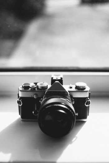 Grayscale Photography of Olympus Dslr Camera Near the Mirror