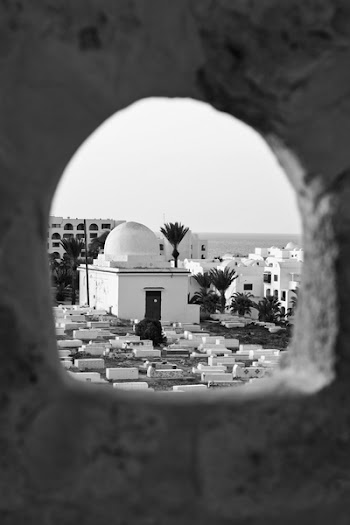 Grayscale Photography of Peep Hole Showing Concrete Building